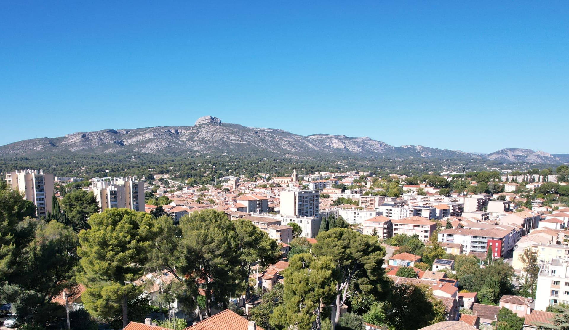 Vue d’Aubagne, de ses toits et de ses collines sous un ciel bleu.